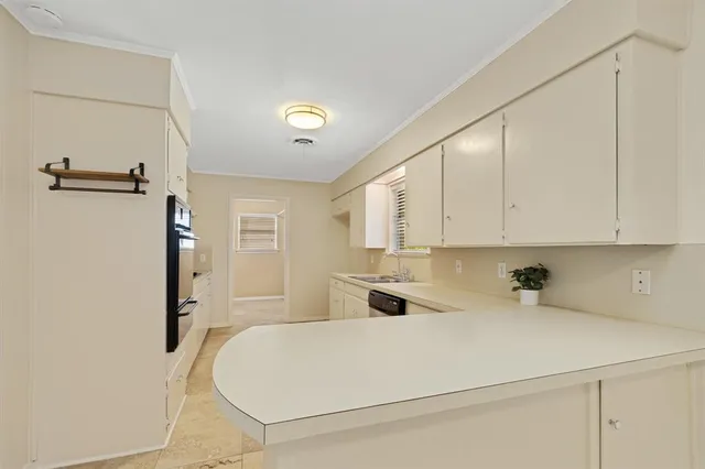 a close view of a sink and cabinets