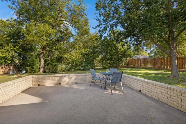 a view of backyard with swimming pool and outdoor seating