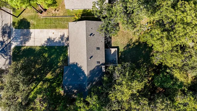 an aerial view of a house with a yard and garden