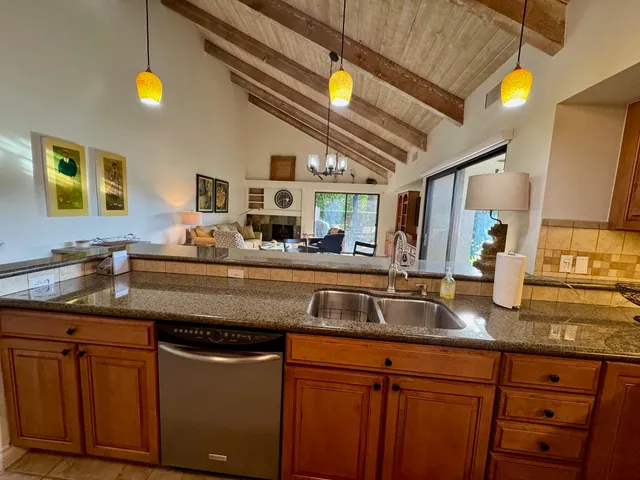a living room with furniture a fireplace and a large window