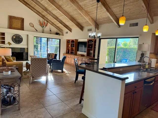 a bedroom with a bed painting on wall and a large window