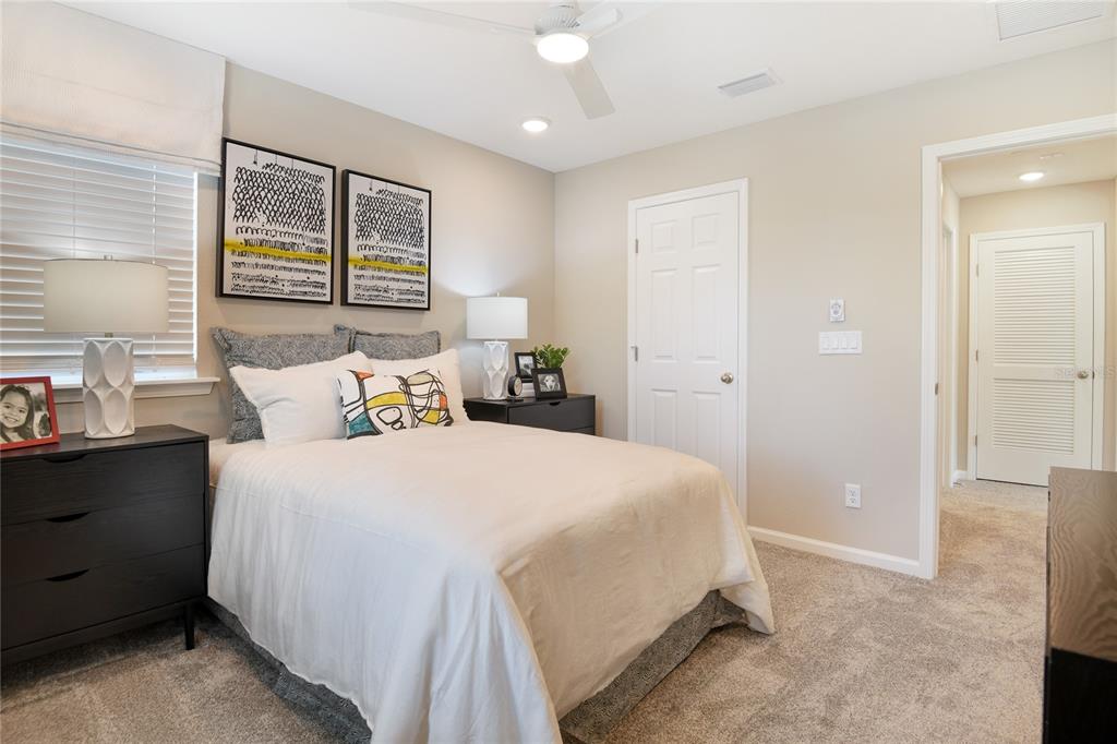 5331 Spring Maiden Circle Apollo Beach, FL 33572 - Photo 22 of 29 a bedroom with a bed and a painting on the wall