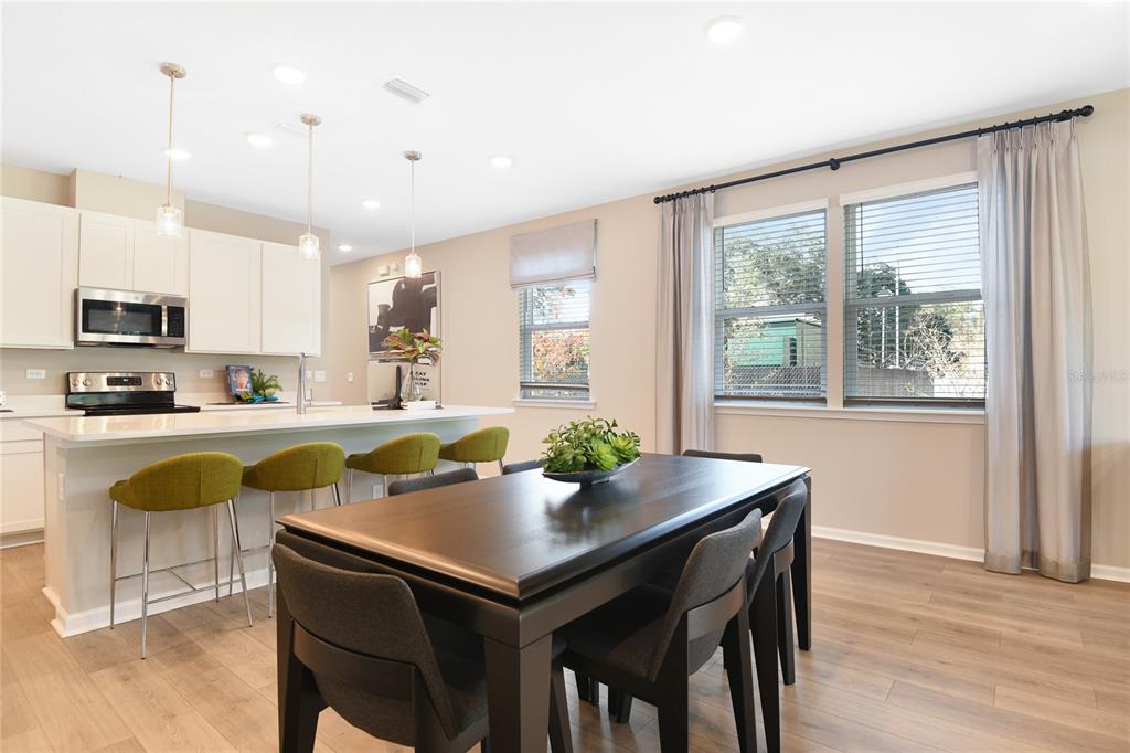 5331 Spring Maiden Circle Apollo Beach, FL 33572 - Photo 10 of 29 a kitchen with a table chairs sink and microwave