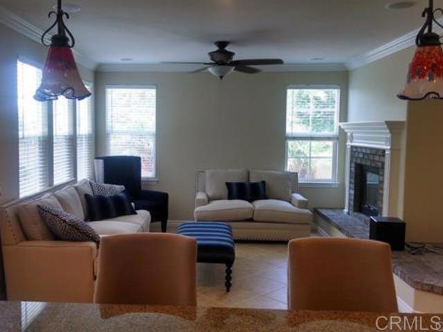 2692 Bressi Ranch Way Carlsbad, CA 92009 - Photo 2 of 4 a living room with furniture a large window and a fireplace