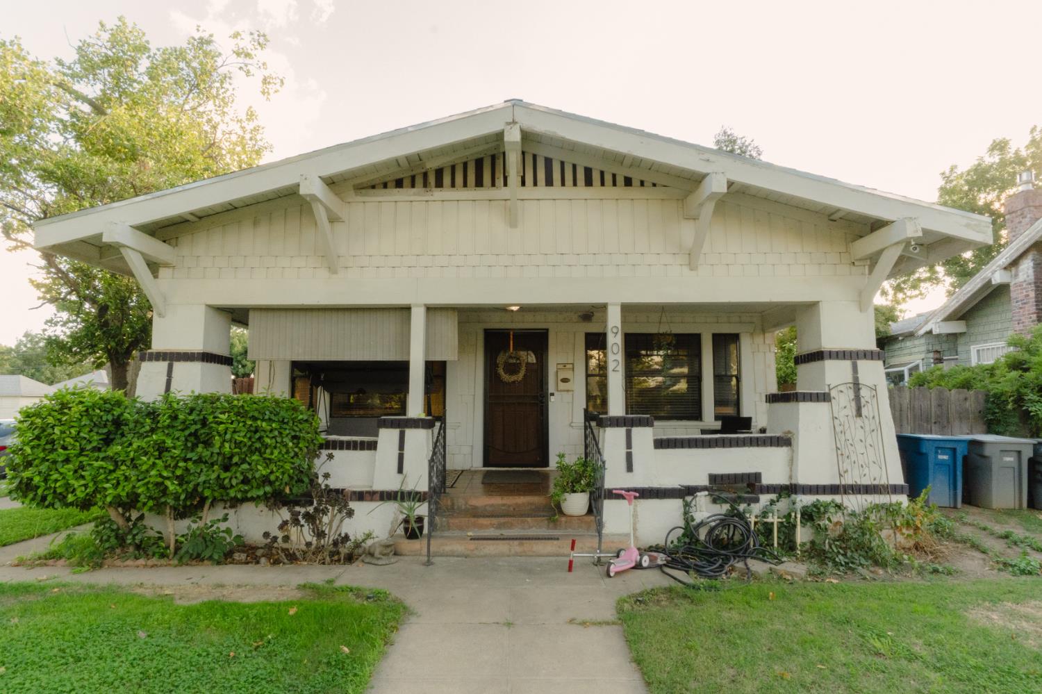 a front view of a house with a garden and plants
