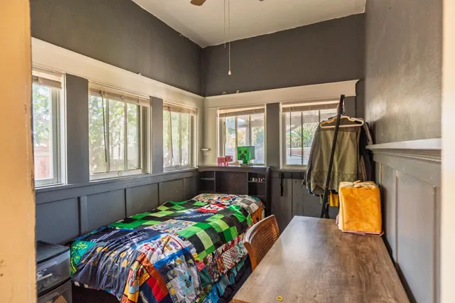 a bedroom with bed and windows