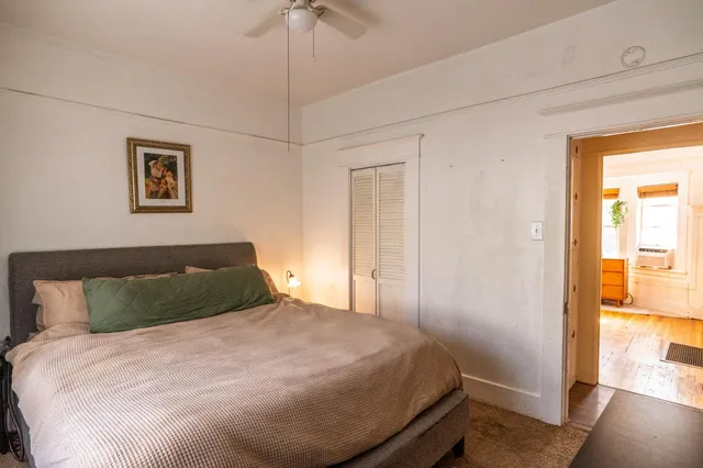 a bed sitting in a bedroom next to a window