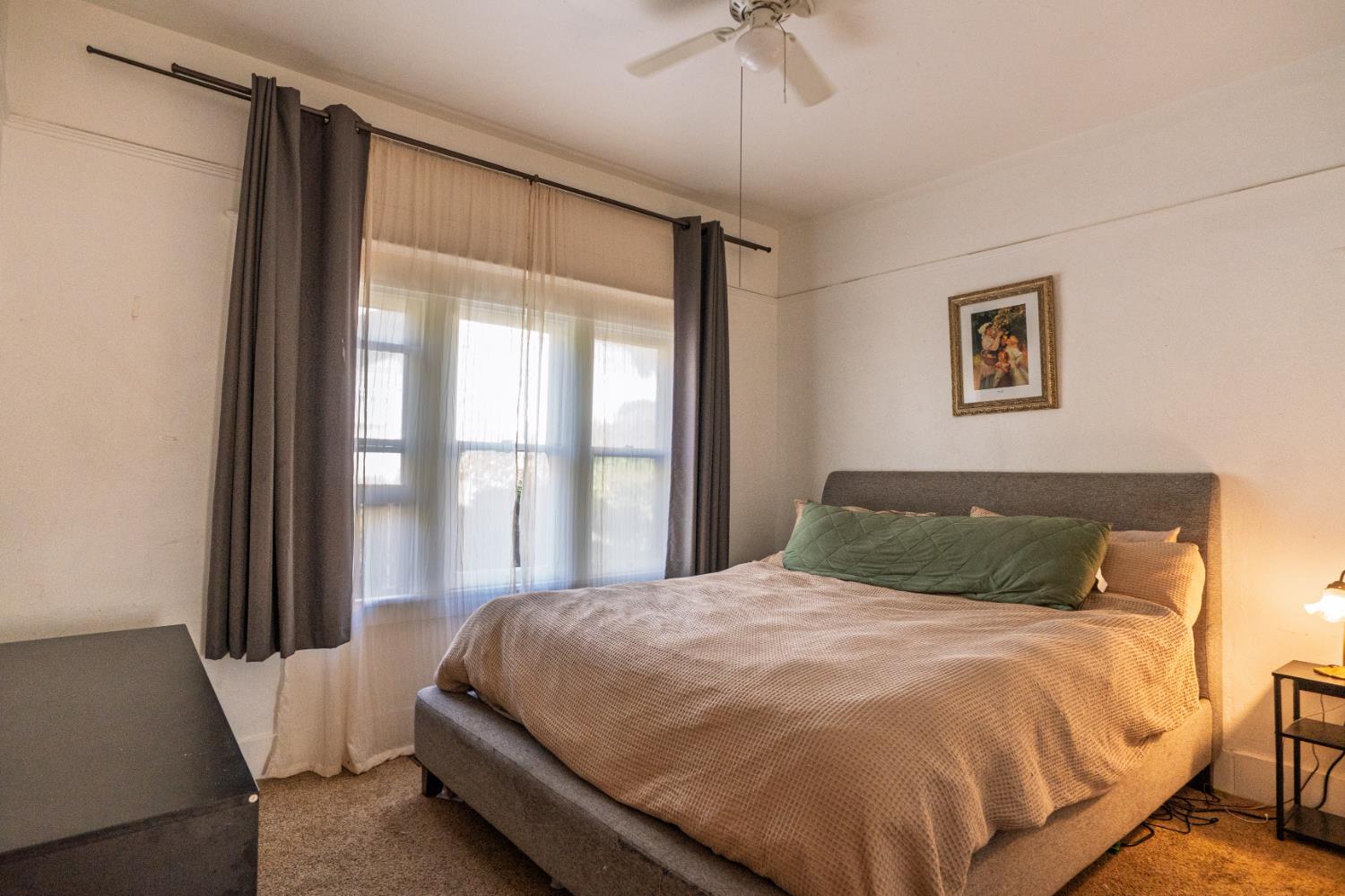 902 West 20th Street Merced, CA 95340 - Photo 18 of 48 a bed sitting in a bedroom next to a window