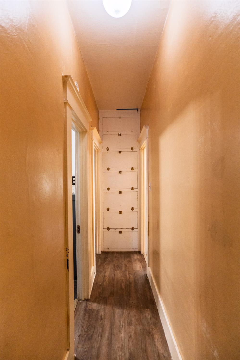 902 West 20th Street Merced, CA 95340 - Photo 26 of 48 a view of a hallway with wooden floor