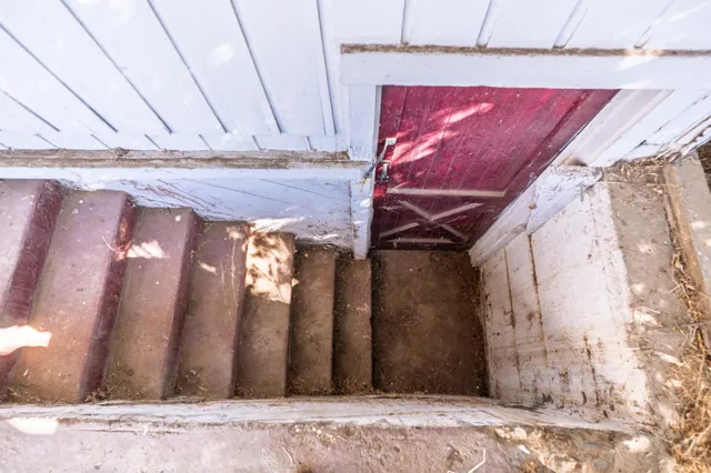 a view of a porch with wooden floor and fence
