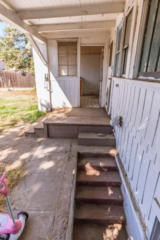 a yellow house with yard in front of it