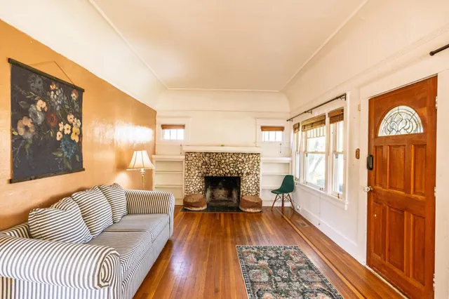 a living room with furniture and a fireplace