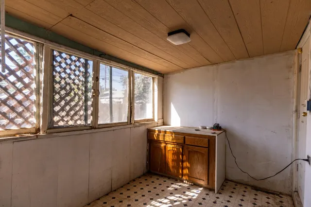a view of house with backyard and wooden fence