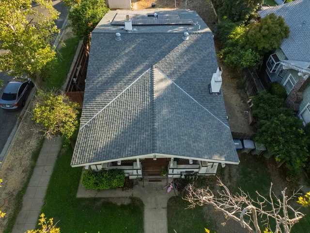 an aerial view of a house with a yard