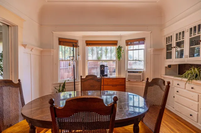 a view of a dining room with furniture window and wooden floor
