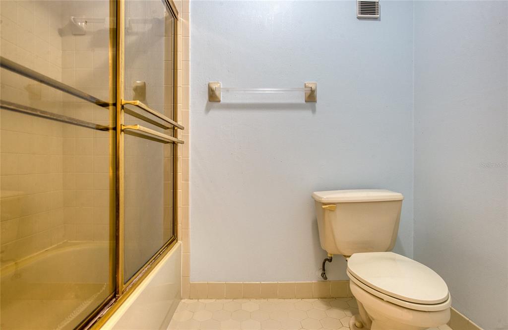 700 Starkey Road, Unit 1145 Largo, FL 33771 - Photo 38 of 63 a white toilet sitting next to a shower