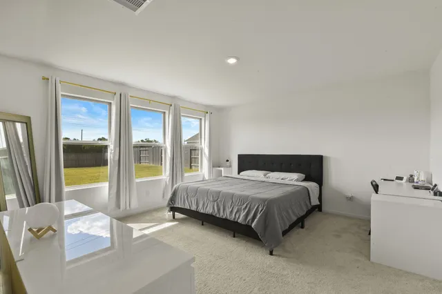 a bedroom with a bed and glass window