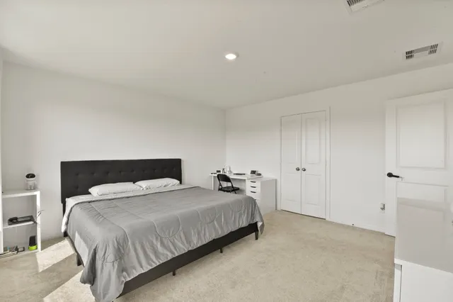 a bedroom with a bed and a lamp