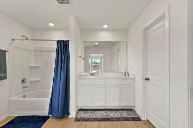 a bathroom with a bathtub and a sink