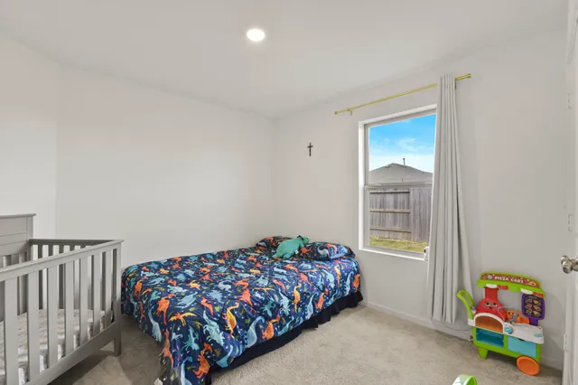 a bedroom with a bed and a window