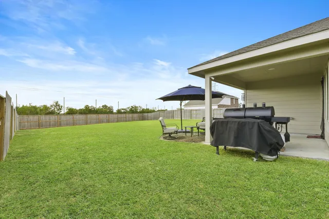a view of a backyard with sitting area