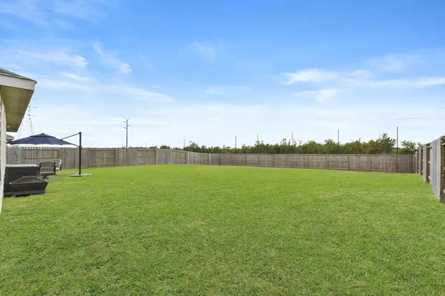 a view of a field of grass and houses