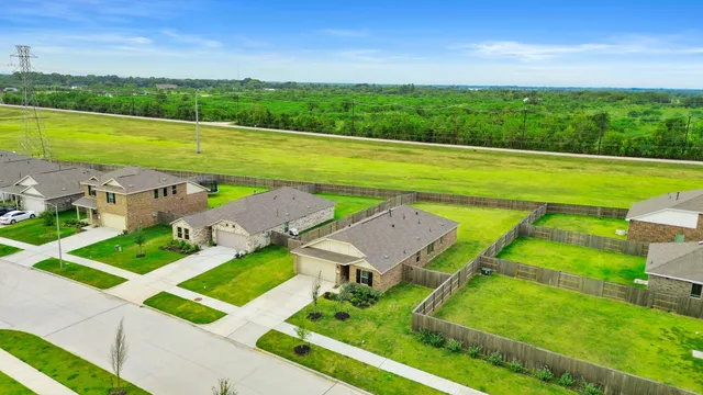 an aerial view of a house with big yard