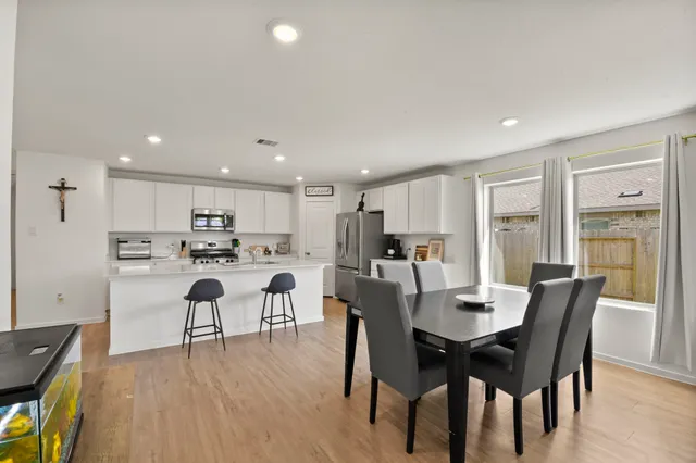 a view of a dining room with furniture and wooden floor
