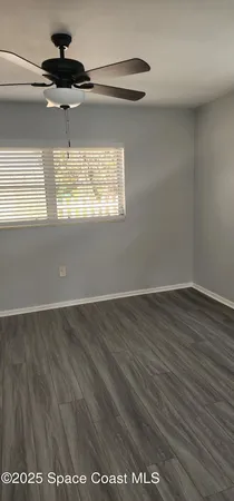 an empty room with wooden floor