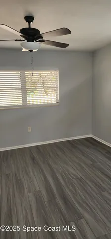 an empty room with wooden floor