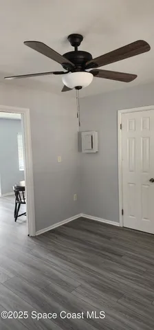 a view of a room with wooden floor and air conditioner