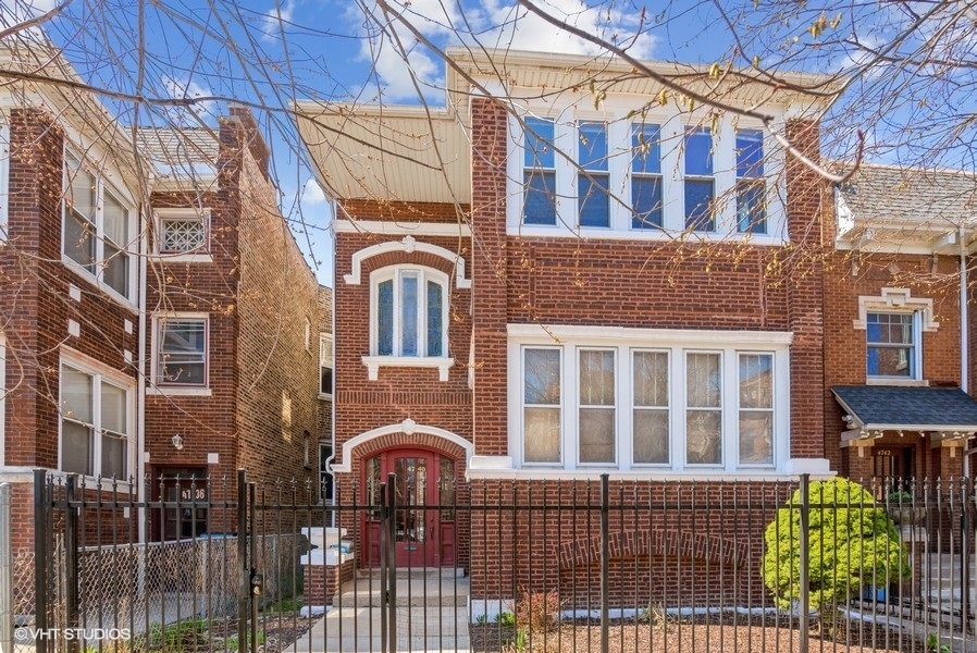 4740 North Troy Street, Unit 1 Chicago, IL 60625 - Photo 1 of 11 a front view of a building with glass windows