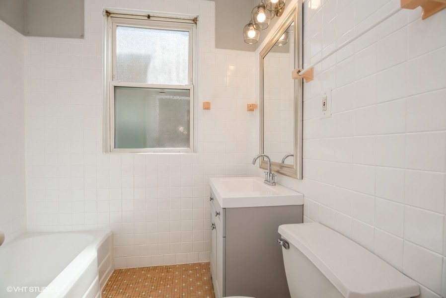 4740 North Troy Street, Unit 1 Chicago, IL 60625 - Photo 10 of 11 a bathroom with a sink toilet and tub