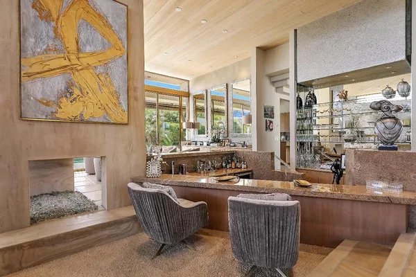 a room with furniture and large windows