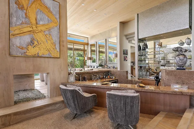 a room with furniture and large windows