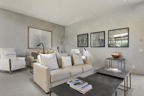 a living room with furniture and painting on the wall