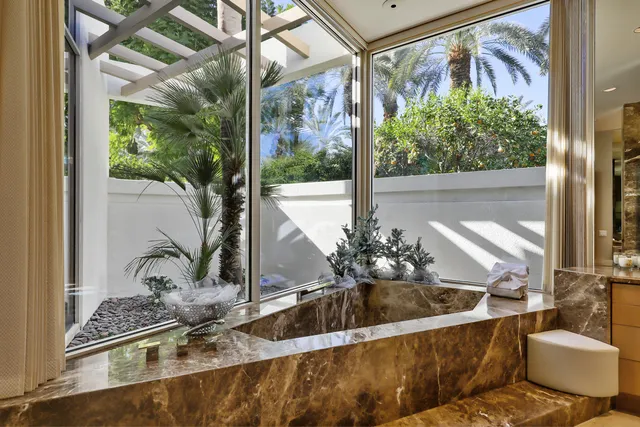 a view of a living room with a floor to ceiling window and floor
