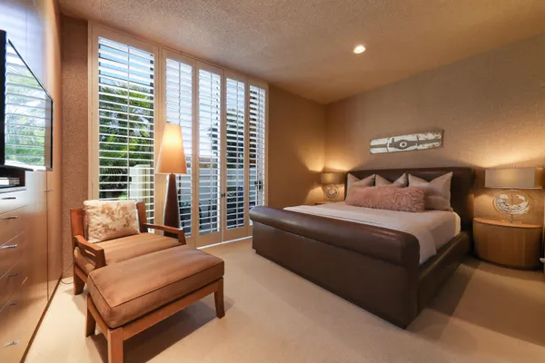 a bedroom with bed and window