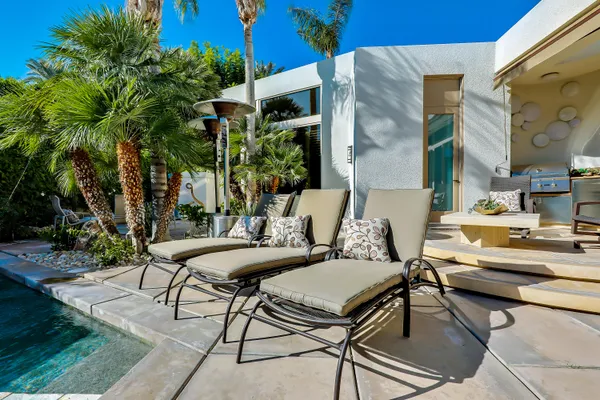a view of a patio with table and chairs and potted plants