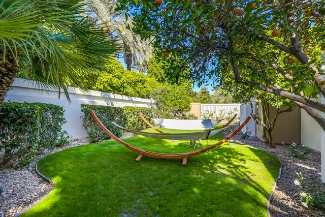 a view of a chair and table in backyard
