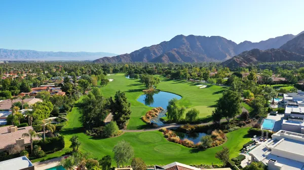 a view of a lush green hillside and houses