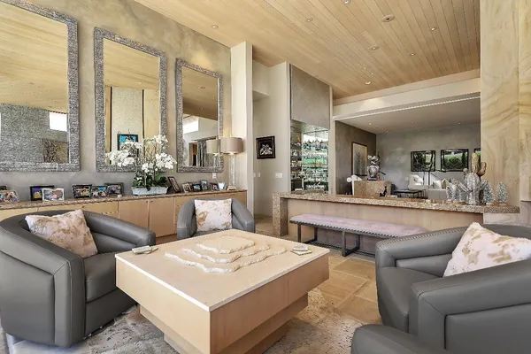 a large living room with stainless steel appliances kitchen island granite countertop furniture and a large window