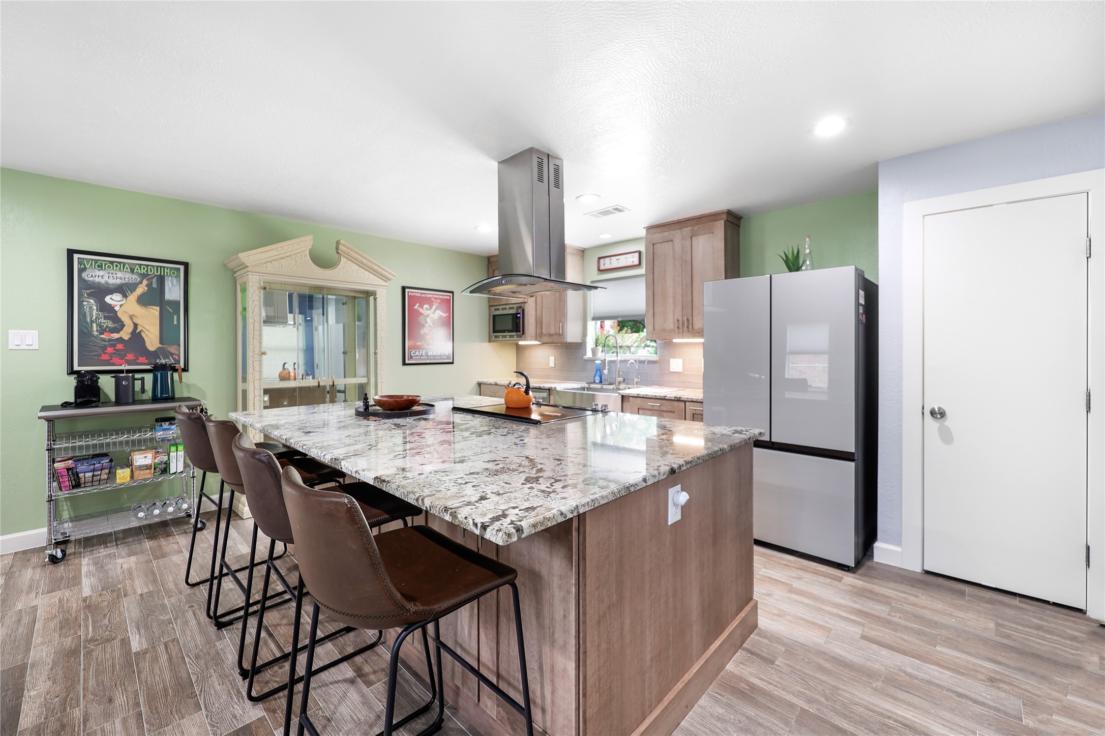 28831 South Diamondhead Conroe, TX 77356 - Photo 4 of 29 a kitchen with stainless steel appliances granite countertop a refrigerator a stove and a wooden floors