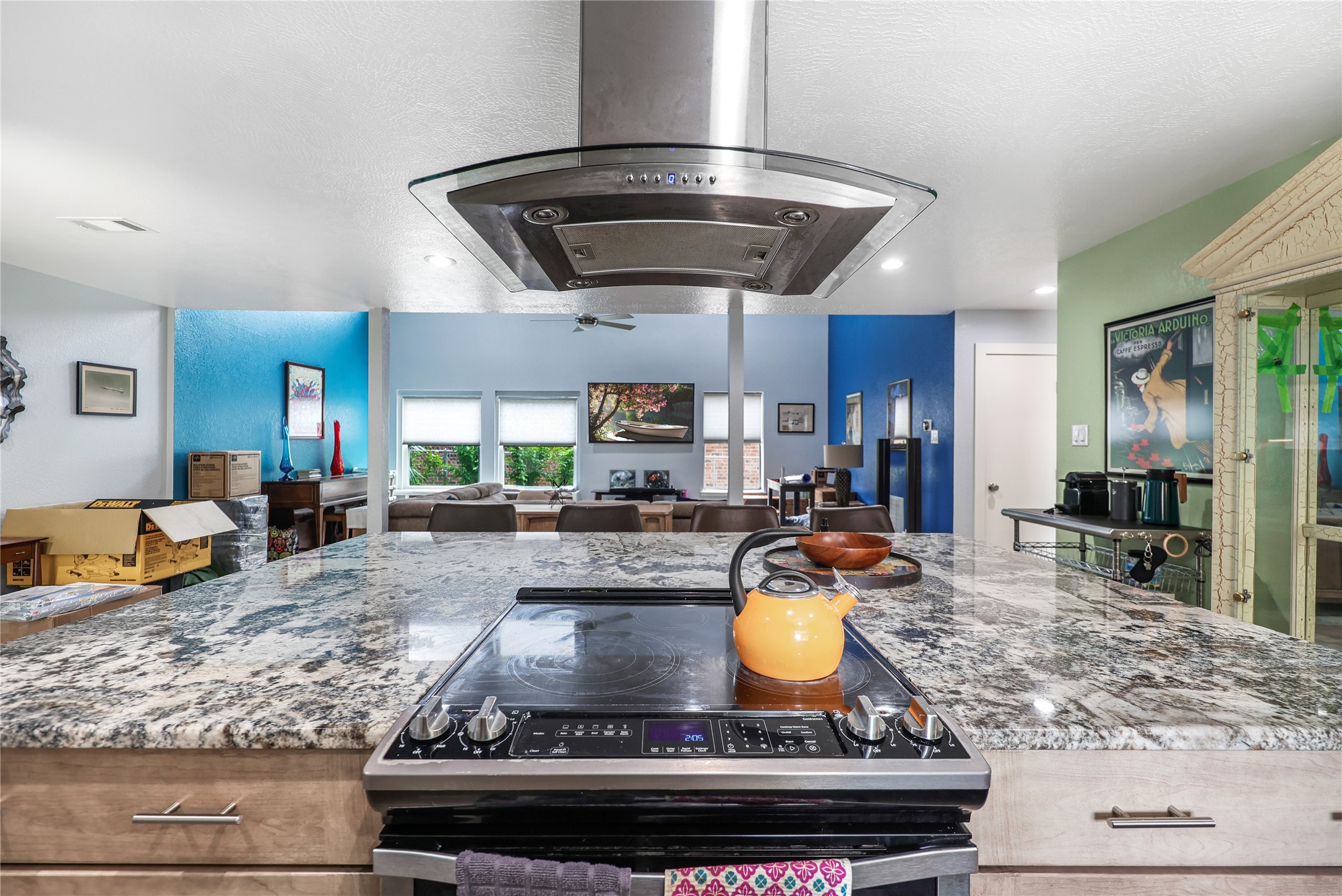 28831 South Diamondhead Conroe, TX 77356 - Photo 6 of 29 a kitchen with stainless steel appliances granite countertop a stove top oven a dining table and chairs with wooden floor