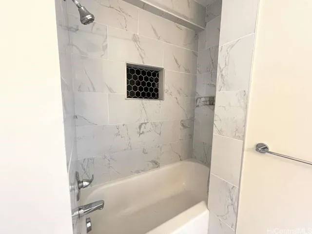 a bathroom with a bathtub and shower