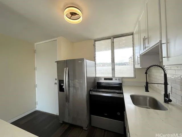 a kitchen with a refrigerator and a sink