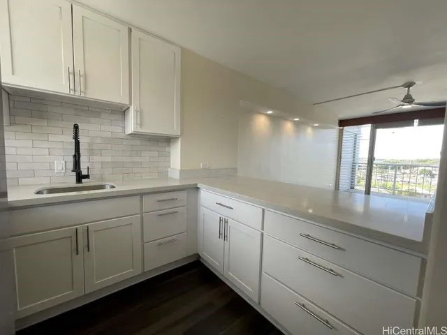a kitchen with sink cabinets and window
