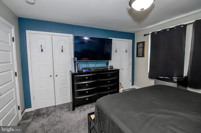 a room with a dresser and a flat screen tv