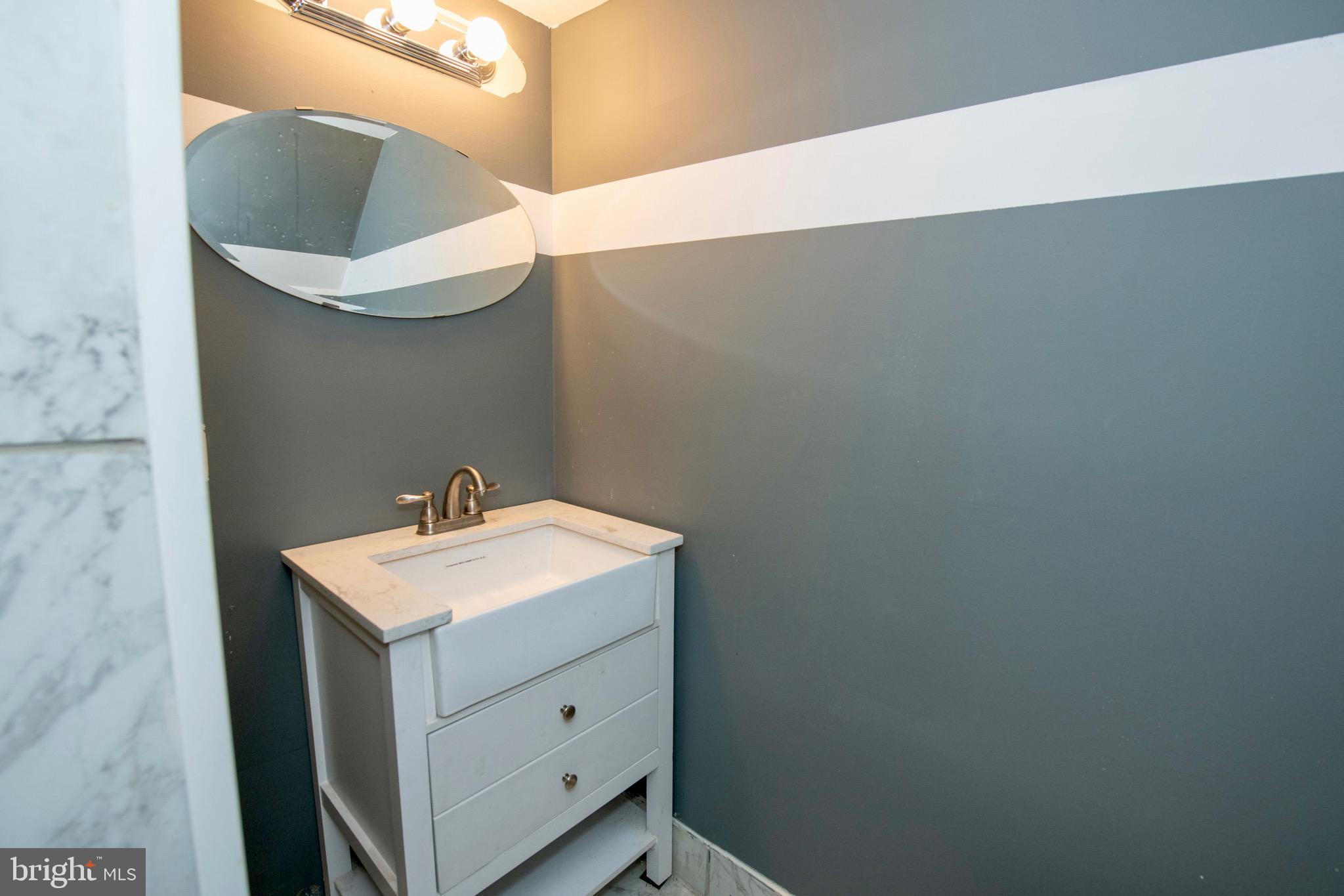 4930 Pulaski Avenue Philadelphia, PA 19144 - Photo 14 of 22 a bathroom with a sink and mirror