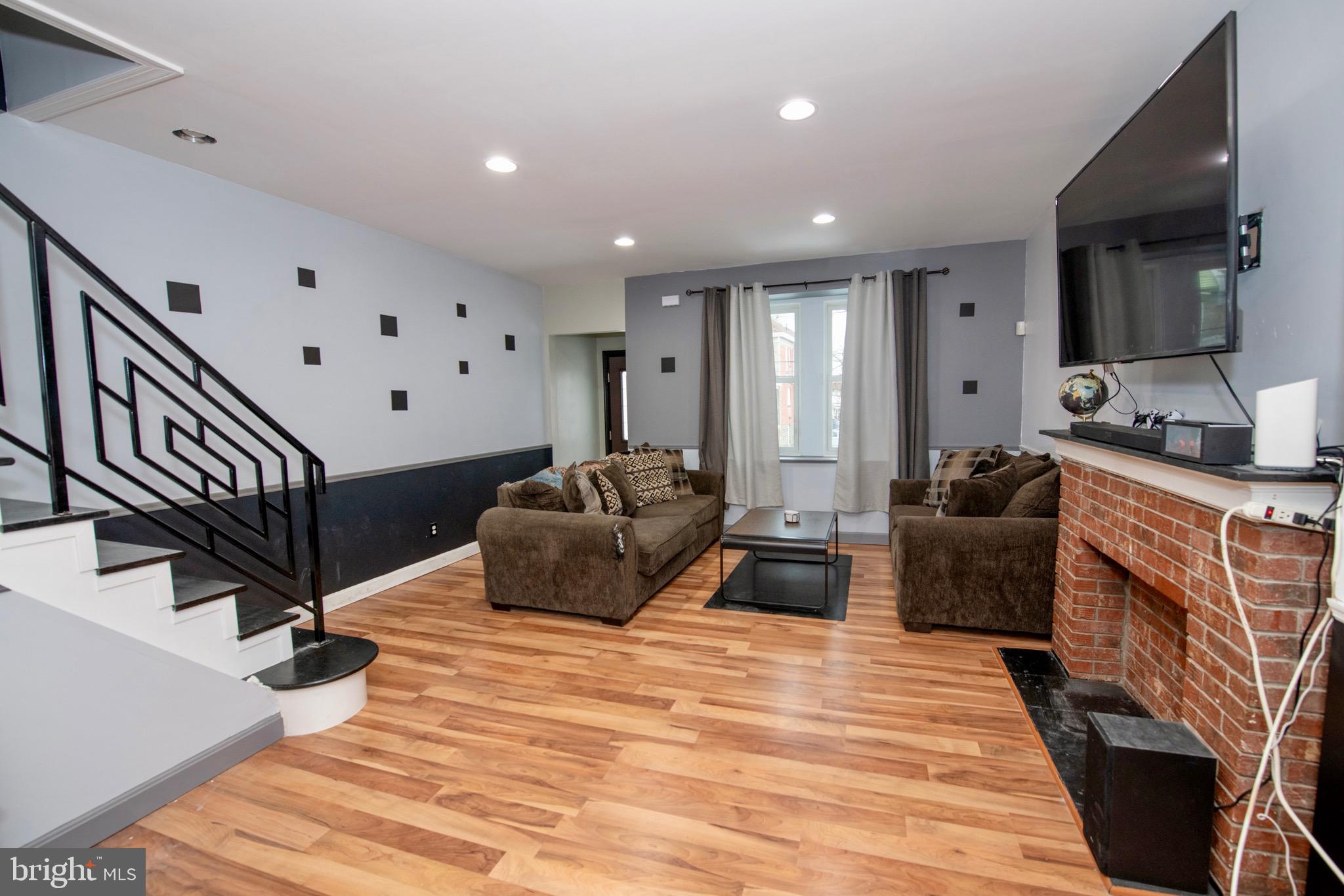 4930 Pulaski Avenue Philadelphia, PA 19144 - Photo 5 of 21 a large bedroom with a bed and a flat screen tv